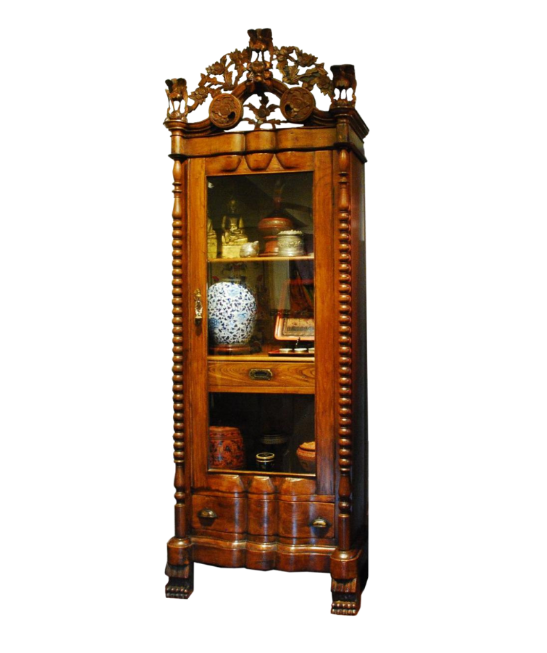 A fine display cabinet with a single glass door, 3 drawers below,  carved floral designs around the beveled slanted roof, Bearclaw feet